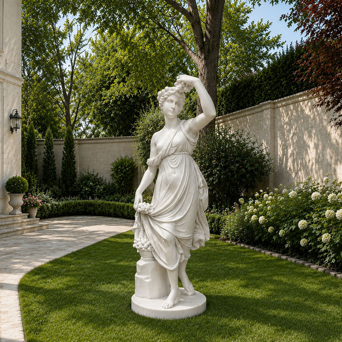 White marble goddess sculpture displayed in a luxury garden, classical female statue with flowing dress and elegant outdoor landscaping