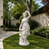 White marble goddess sculpture displayed in a luxury garden, classical female statue with flowing dress and elegant outdoor landscaping