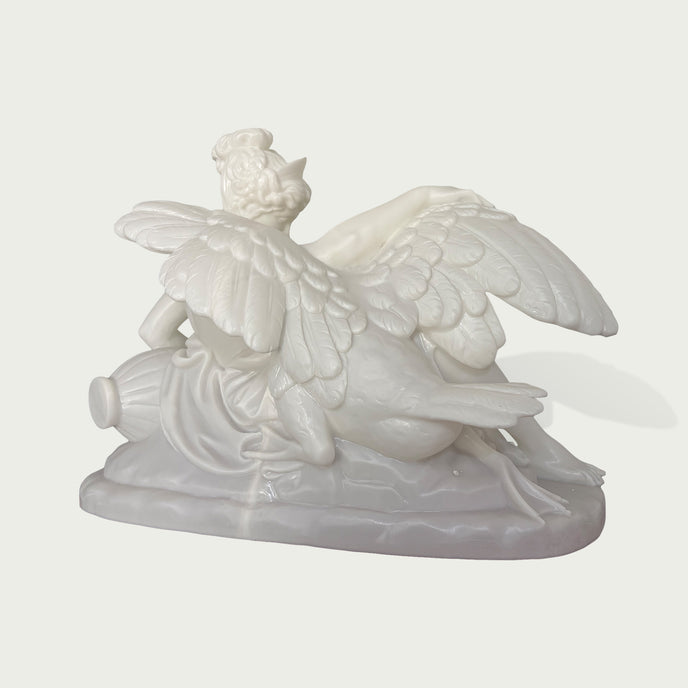Side view of a white marble angel sculpture with detailed wings, elegant pose, and smooth classical stone carving