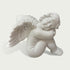 Close view of a white marble angel cherub sculpture with smooth carved details, feathered wings and tranquil sleeping design.