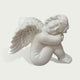 Close view of a white marble angel cherub sculpture with smooth carved details, feathered wings and tranquil sleeping design.