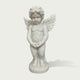 White marble winged cherub statue standing on a round base, featuring carved feather wings, curly hair, childlike figure, and classical angel sculpture details.