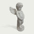 Side view of a white marble cherub angel statue showing detailed wing carving, curly hair, standing child figure, and elegant stone craftsmanship.