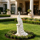 White marble peacock garden statue displayed on a pedestal in a luxury landscape, with detailed feather carving and elegant outdoor architectural setting.