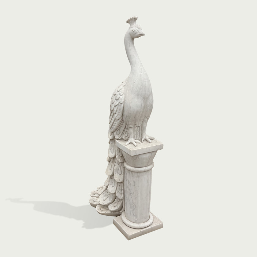 Classical white marble peacock bird sculpture featuring smooth body carving, detailed feathers, decorative pedestal, and timeless garden art style.