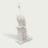 White marble peacock statue profile view with carved feather layers, slender neck, detailed crest, and elegant pedestal base for garden decor.