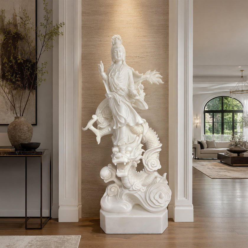White marble Guanyin statue riding a dragon displayed in a luxury interior space, featuring detailed carving, elegant religious symbolism, and classical decor style.