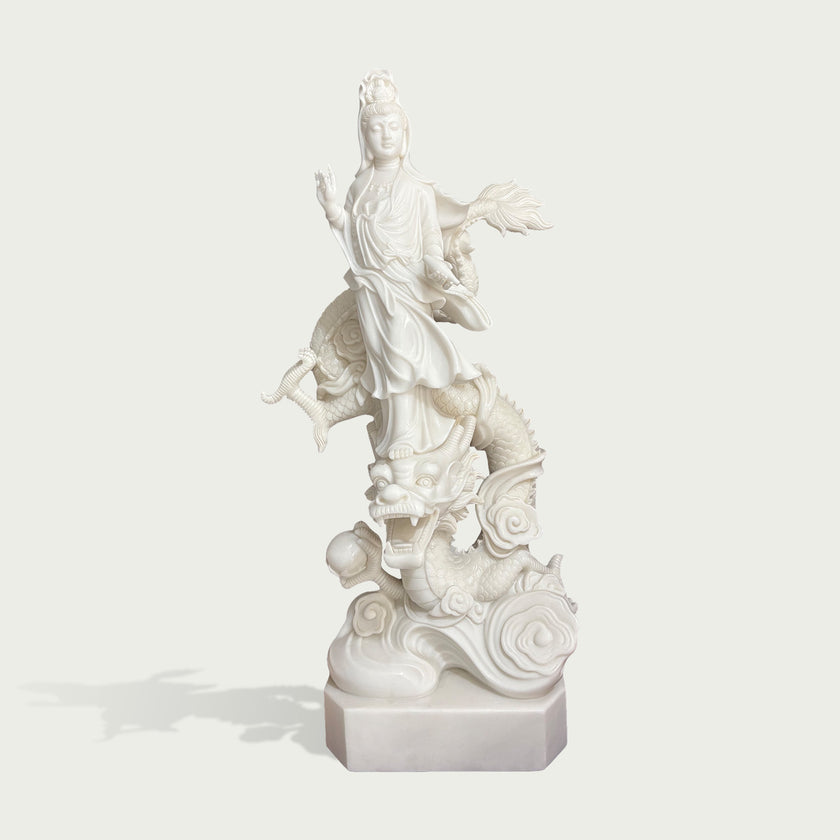 White marble Guanyin Bodhisattva dragon statue sculpture with intricate robe carving, flowing lotus details, mythical dragon base, and handcrafted stone artwork.
