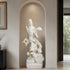 White marble Guanyin Bodhisattva sculpture with dragon and cloud motifs placed in a modern wall niche, showcasing fine craftsmanship and spiritual art design.