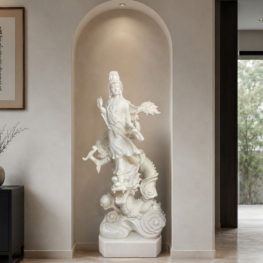 White marble Guanyin Bodhisattva sculpture with dragon and cloud motifs placed in a modern wall niche, showcasing fine craftsmanship and spiritual art design.
