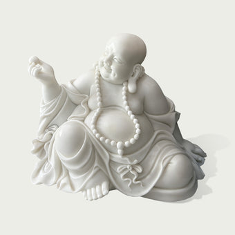 Close view of hand carved white marble Maitreya Buddha statue with detailed facial expression, beaded necklace, smooth stone texture, and traditional Buddhist artistry.