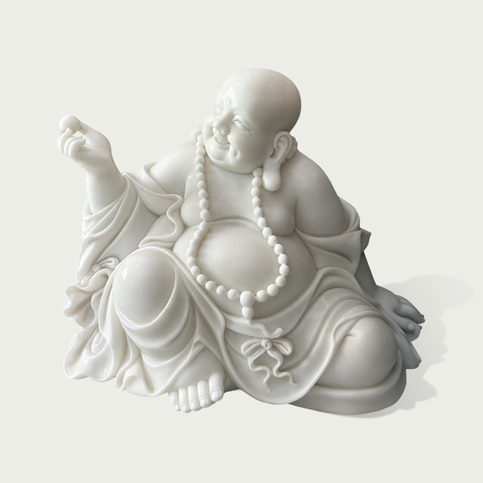 Close view of hand carved white marble Maitreya Buddha statue with detailed facial expression, beaded necklace, smooth stone texture, and traditional Buddhist artistry.