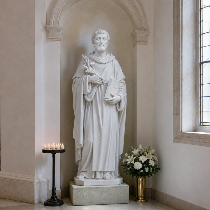 White marble religious statue of a saint with detailed robe folds, holding a sacred book and flowers, placed inside an elegant church interior with soft lighting.