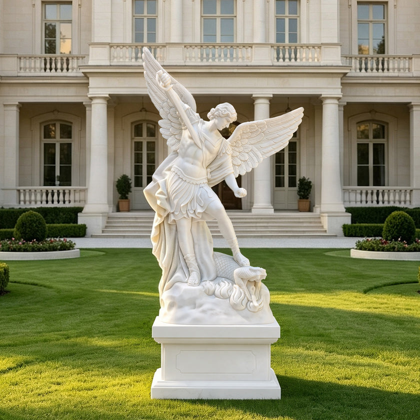 White marble Saint Michael the Archangel garden sculpture displayed outdoors, featuring dramatic wings, sword, dragon base and elegant architectural setting.