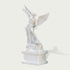 Three-quarter view of a polished white marble Archangel Michael sculpture standing on pedestal with detailed wings, robe folds and carved dragon figure.