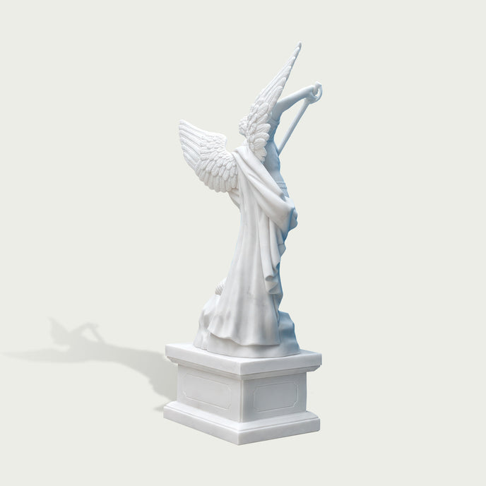 Rear view of white marble Saint Michael angel statue showing large feathered wings, flowing cloak details and handcrafted stone sculpture finish.