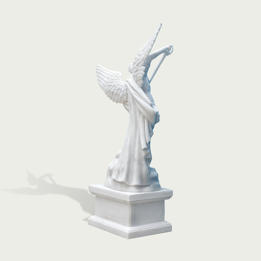 Rear view of white marble Saint Michael angel statue showing large feathered wings, flowing cloak details and handcrafted stone sculpture finish.