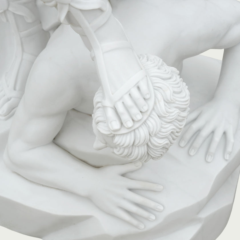 Detailed view of white marble Saint Michael sculpture featuring carved hand, weapon details, flowing textures and refined classical marble carving.