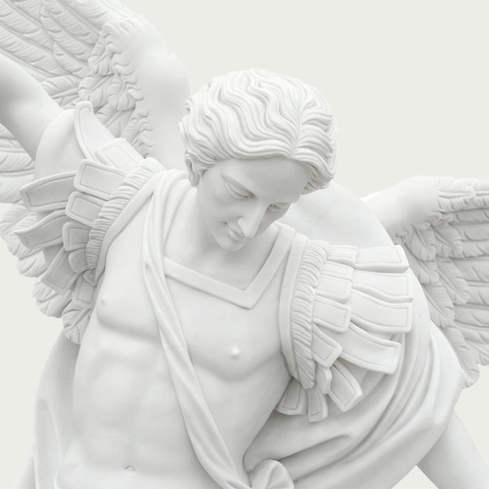 Close-up of white marble Saint Michael the Archangel statue showing facial expression, carved hair, wings and elegant Renaissance-inspired details.