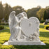 Elegant white marble angel heart grave monument featuring a kneeling angel, detailed feather wings, floral carvings and smooth polished stone surface for memorial decoration.