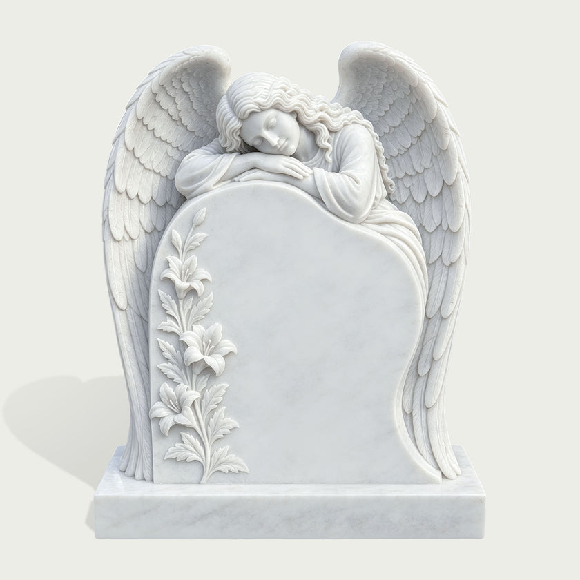 White marble sleeping angel memorial headstone featuring a peaceful female angel resting above a blank inscription panel, detailed feathered wings, carved lilies, and a rectangular marble base.