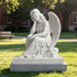 White marble seated mourning angel sculpture displayed outdoors, with a blindfolded face resting on one hand, detailed feathered wings, flowing drapery, and a rectangular marble base.
