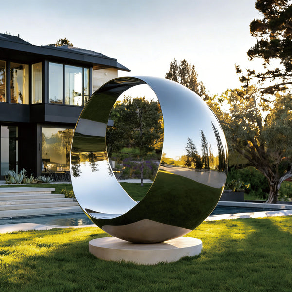 Modern outdoor Stainless Steel Round O-ring sculpture in front of a house with a pool