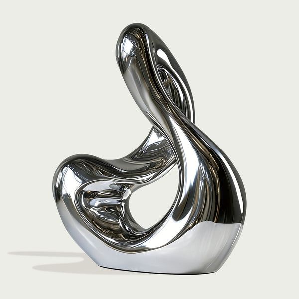 Stainless Steel Modern silver sculpture in a garden setting with a contemporary building in the background