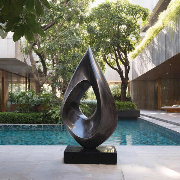 Stainless Steel Abstract sculpture by a pool with modern building and greenery in the background