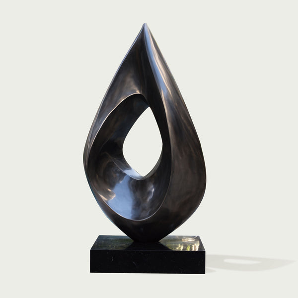 Stainless Steel Abstract sculpture by a pool with modern building and greenery in the background