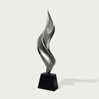 Abstract stainless steel sculpture on a black base 