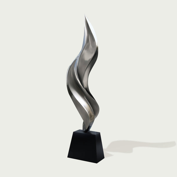 Abstract stainless steel sculpture on a black base 