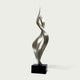Soaring Ribbon Twisting Stainless Steel Sculpture on a black base against a white background