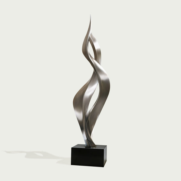 Modern tewsting silver stainless steel sculpture  on a white background