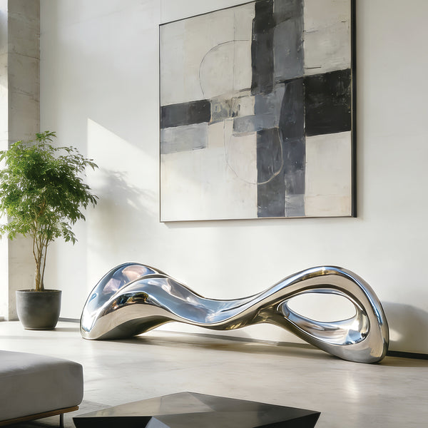 Modern Stainless Steel silver bench sculpture in a stylish living room with abstract art and plant.