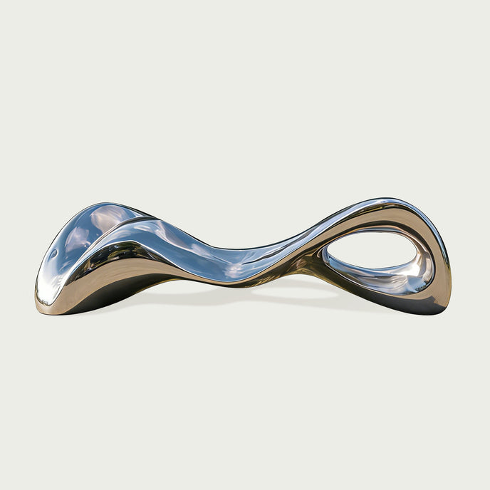 Modern Stainless Steel silver bench sculpture on a light gray background