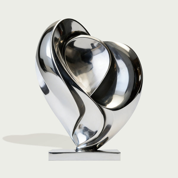 Modern stainless steel silver blooming heart sculpture on a white background