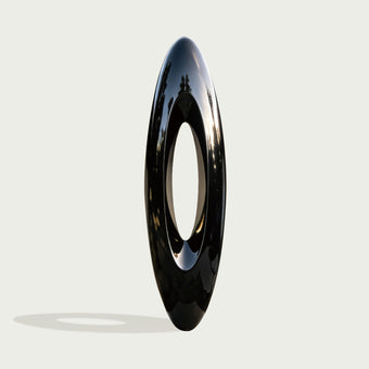 Large Abstract Black Oval Stainless Steel Sculpture on a light gray background