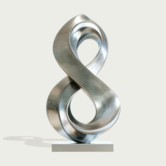 Fluid Infinity Loop Stainless Steel Sculpture on a light gray background