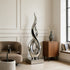  Modern Contemporary Floor Sculpture Stainless Steel Silver Ember with a large armchair, and side table.