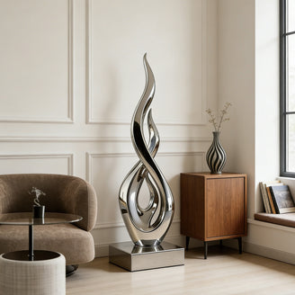  Modern Contemporary Floor Sculpture Stainless Steel Silver Ember with a large armchair, and side table.