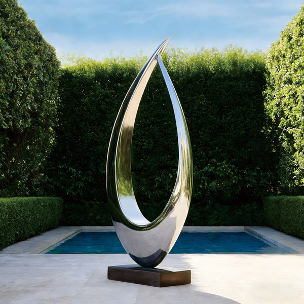 "The Natural Frame" Hollow Silhouette Stainless Steel Sculpture in a garden setting with a pool and greenery.