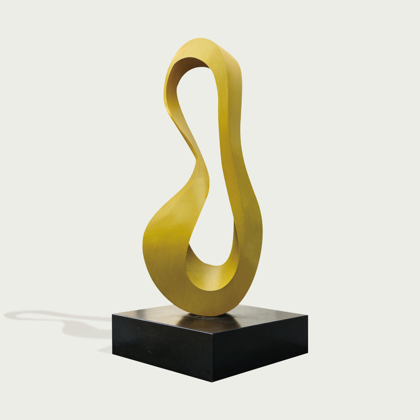 Minimalist Abstract Stainless Steel Sculpture Yellow Curved Loop on white background