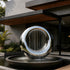 Mirror Polished Stainless Steel Sculpture Eclipse Loop  Water Fountain in front of a contemporary building.