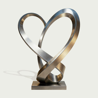 Stainless Steel Sculpture Ascending Heart on a light gray background