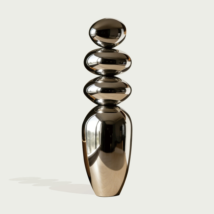 Mirror Polished Balancing Stone Stainless Steel Sculpture on a white background