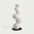 Abstract Floating White Balls Stainless Steel Sculpture  against a light gray background