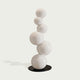 Abstract Floating White Balls Stainless Steel Sculpture  against a light gray background