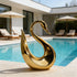 Fluid Silhouette Swan Modern Contemporary Stainless Steel Sculpture by a poolside in a luxury modern house