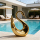 Fluid Silhouette Swan Modern Contemporary Stainless Steel Sculpture by a poolside in a luxury modern house